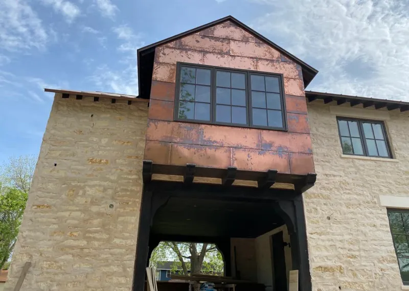 Copper metal panel facade on a stone building for Skylight Installation in Los Fresnos